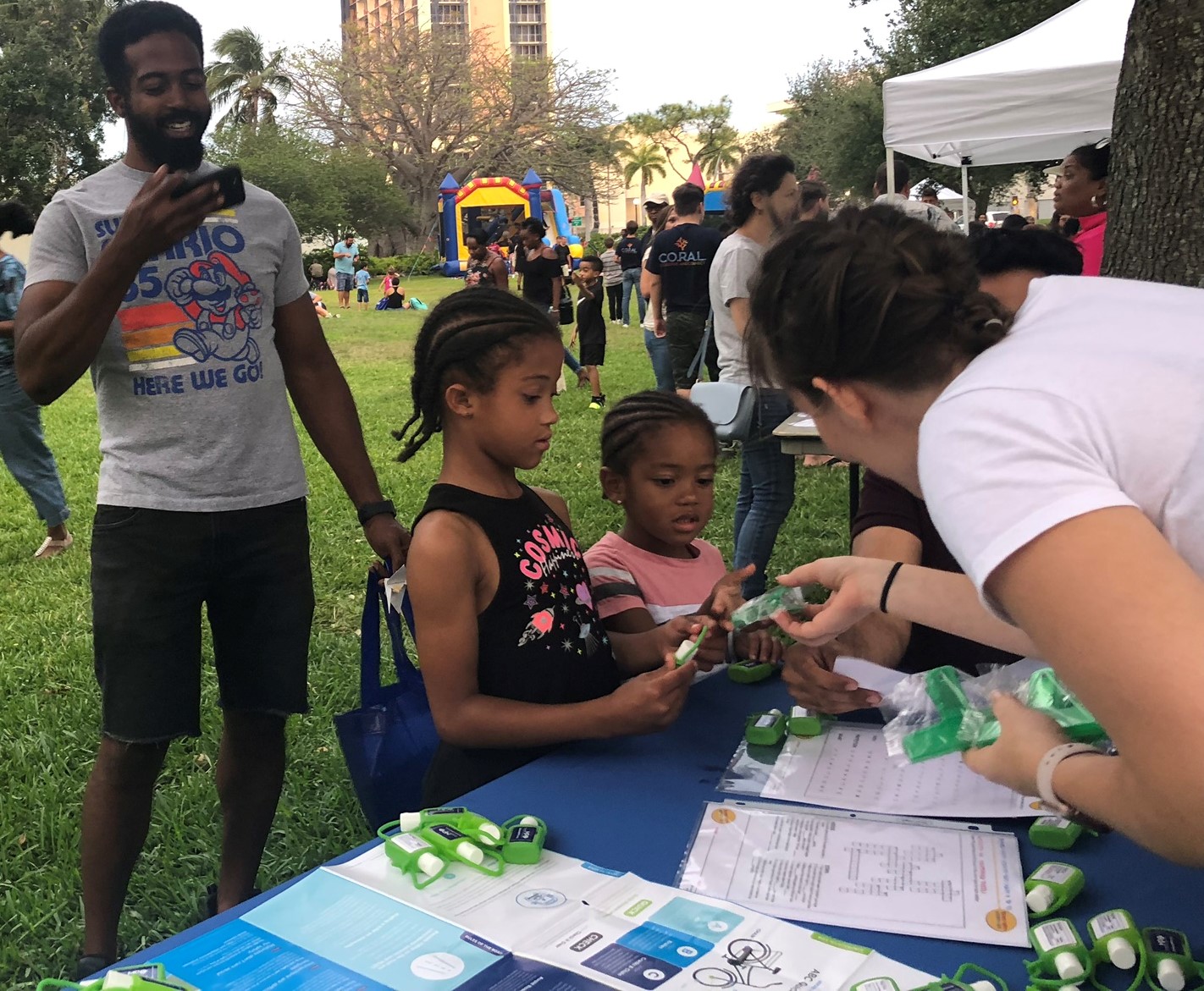 Public Outreach Officer, Hannah, talks with children about environmental benefits of biking